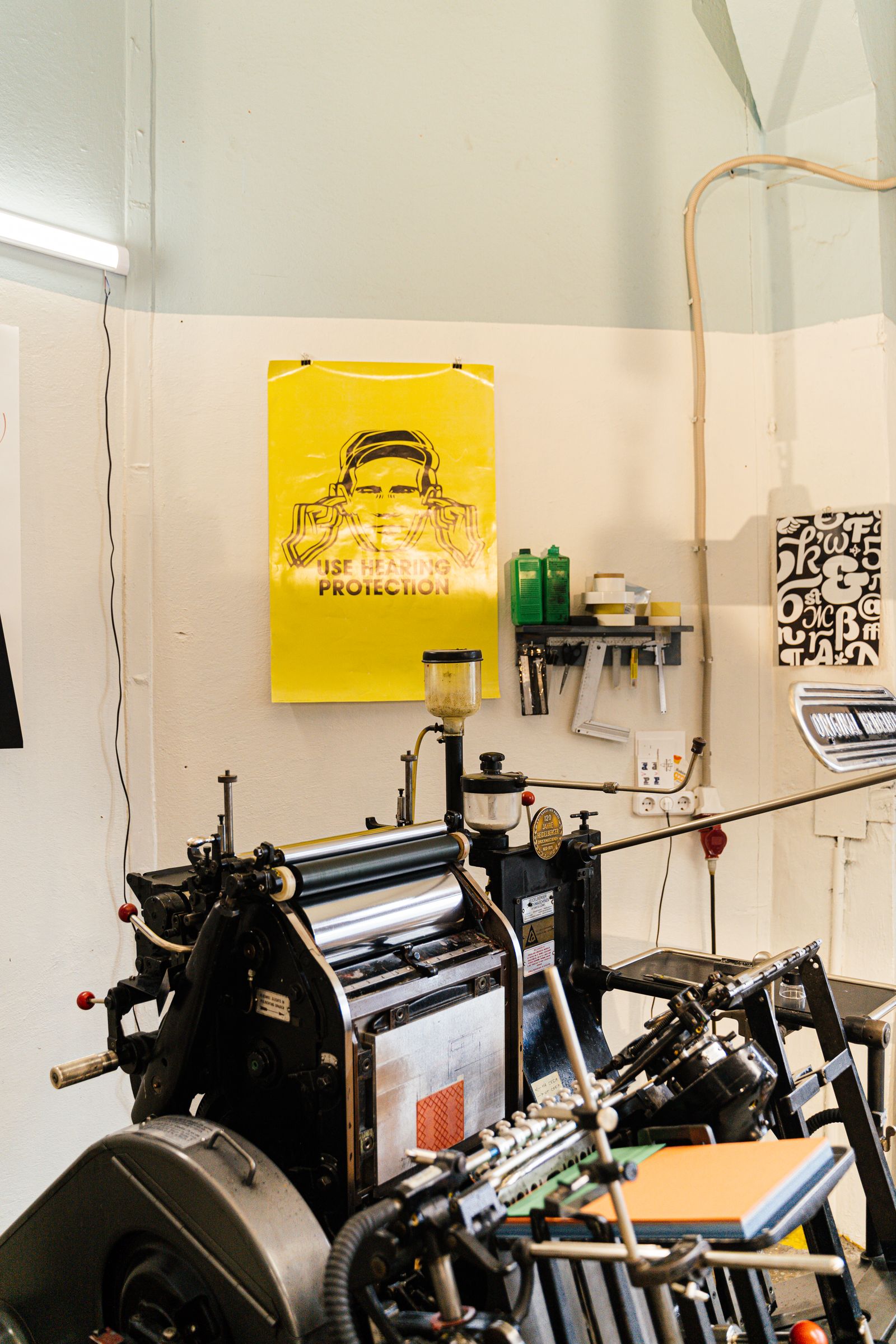 A printing press and posters in a studio